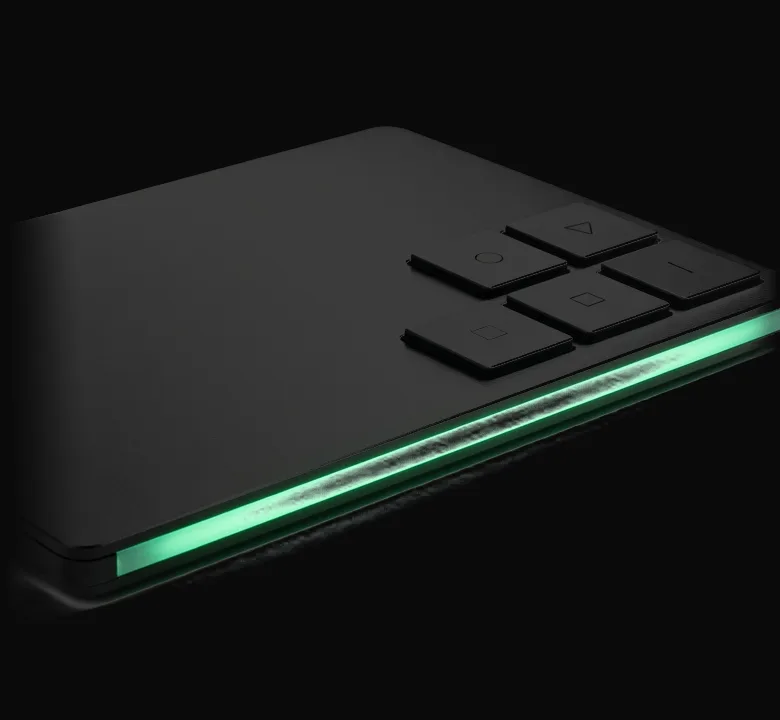 A black console slab standing in the dark, its mint light strip burning along the edge.