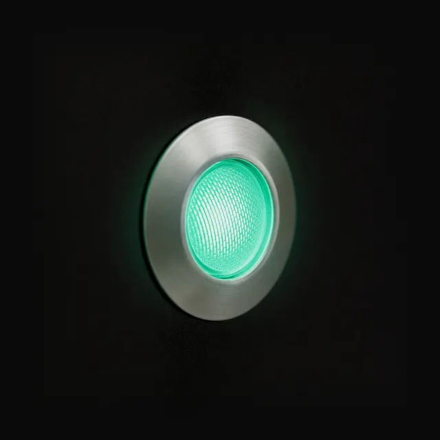 A brushed nickel lamp set into the black panel, lit mint.